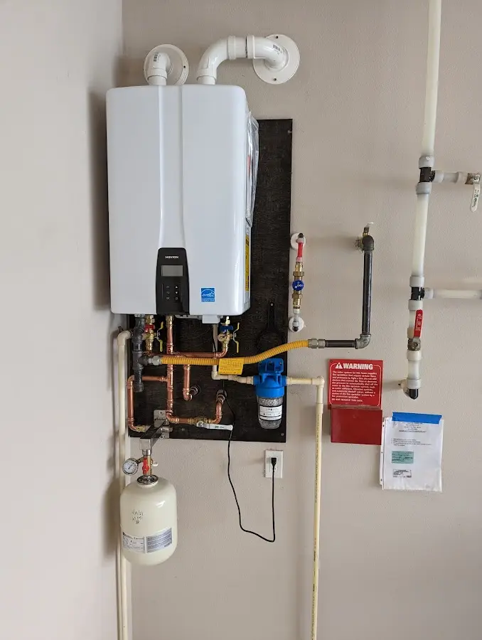 Professional plumber installing copper piping in a Bay Village home